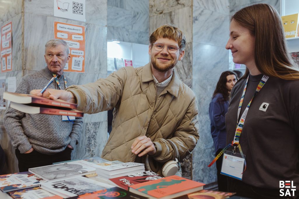 Пісьменнік Макар перадае падпісаныя кнігі падчас Міжнароднага кніжнага кірмашу ў Варшаве. Варшава, Польшча. 17 траўня 2025 года. Фота: Рауль Дзюк / Белсат